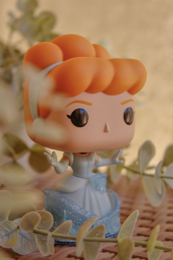 Funko Pop figurine amidst leaves with warm tones, perfect for collectors.